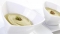 Sicilain Pistachio Spread served in a pair of white bowls with a pistachio nut on top.