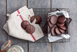 Dark Chocolate Gingers served with a tea towel on a cooling rack.
