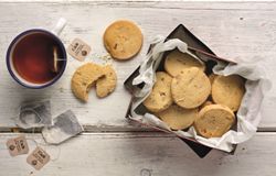 Milk Choc Chunk Biscuits served next to a mug of tea.